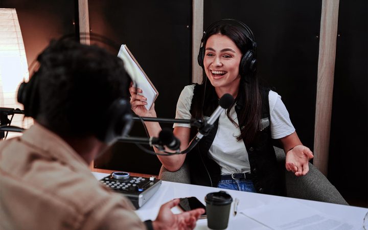 portait-of-happy-female-radio-host-laughing-listen-BJMRMJ3